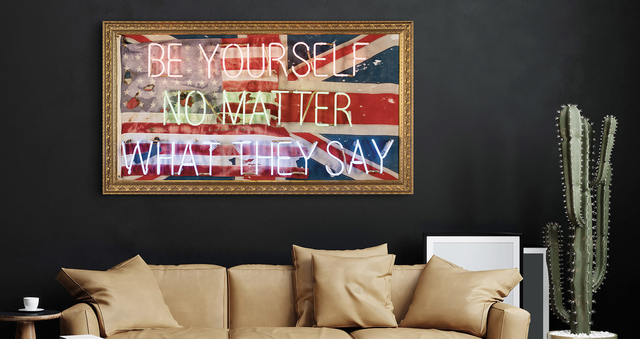 A Mark Sloper neon artwork saying  Be Yourself No Matter What They Say  on top of a flag  